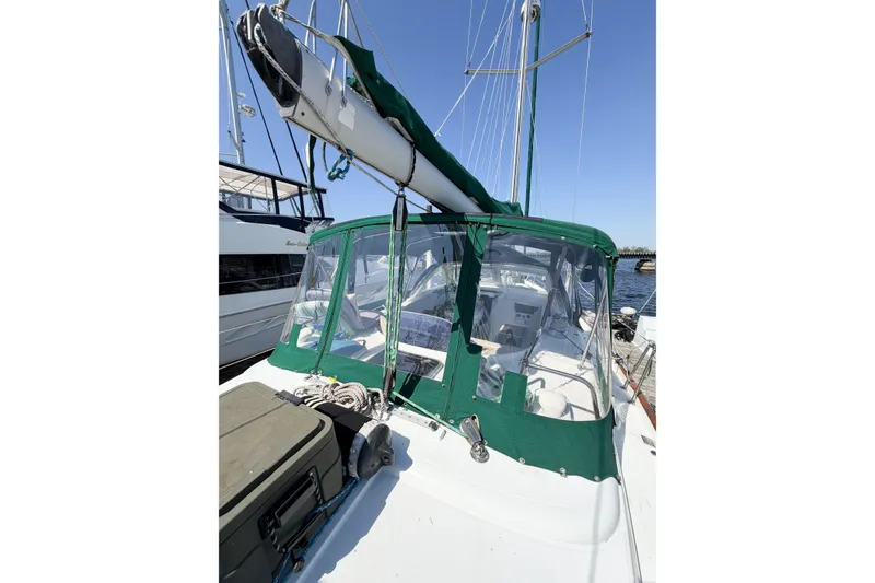 Slide: The Image of 2002 Beneteau Oceanis 42CC sailboat with green canopy docked at marina. - 21