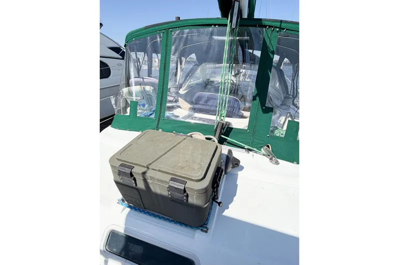 Slide: The Image of Beneteau Oceanis 42CC sailboat deck with green canopy and secured storage box, 2002 model. - 24