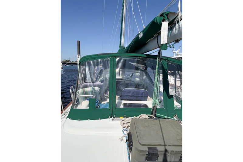 Slide: The Image of 2002 Beneteau Oceanis 42CC sailboat with green canopy, docked on a sunny day. - 25