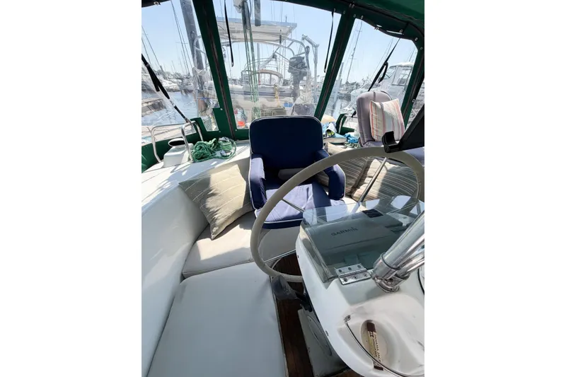 Slide: The Image of Cockpit of 2002 Beneteau Oceanis 42CC sailboat with steering wheel and seating. - 29