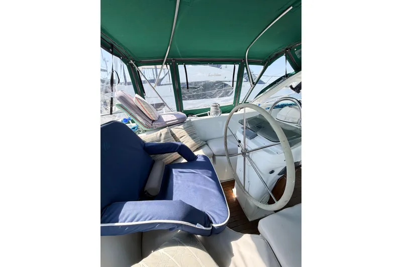 Slide: The Image of Interior view of 2002 Beneteau Oceanis 42CC sailboat cockpit with green canopy and seating. - 30