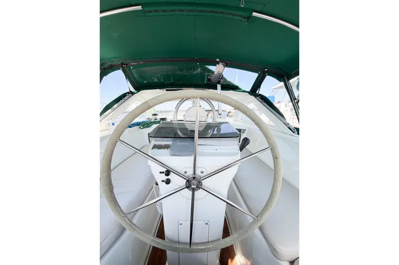 Slide: The Image of Cockpit view of 2002 Beneteau Oceanis 42CC sailboat with green canopy and steering wheel. - 31