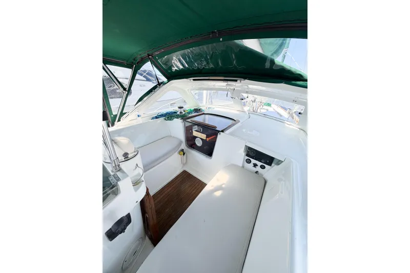 Slide: The Image of Cockpit of 2002 Beneteau Oceanis 42CC sailboat with green canopy and seating area. - 32