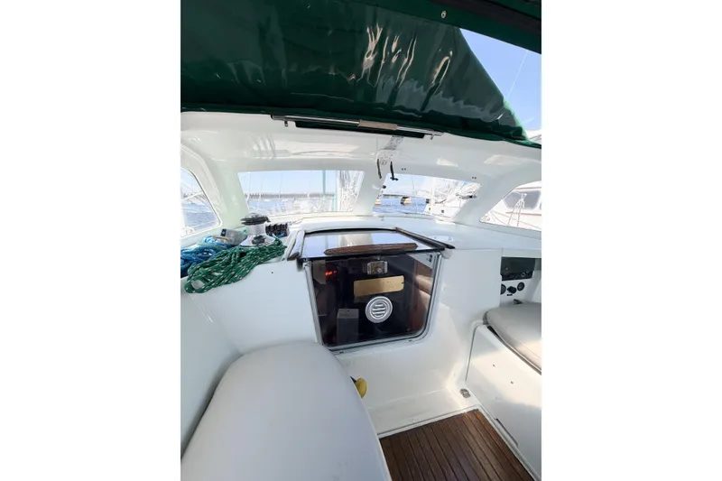 Slide: The Image of Cockpit of 2002 Beneteau Oceanis 42CC sailboat with green canopy and wooden flooring. - 34