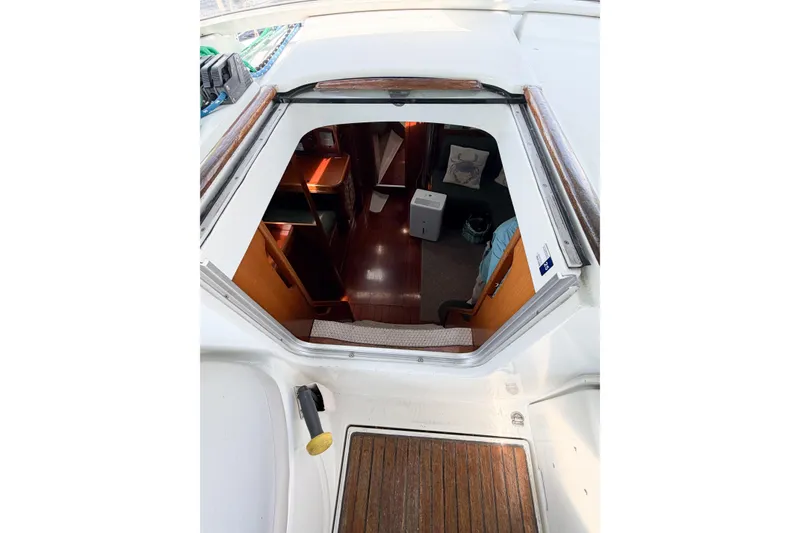 Slide: The Image of Interior view of 2002 Beneteau Oceanis 42CC sailboat, showcasing cabin entrance and wooden flooring. - 39