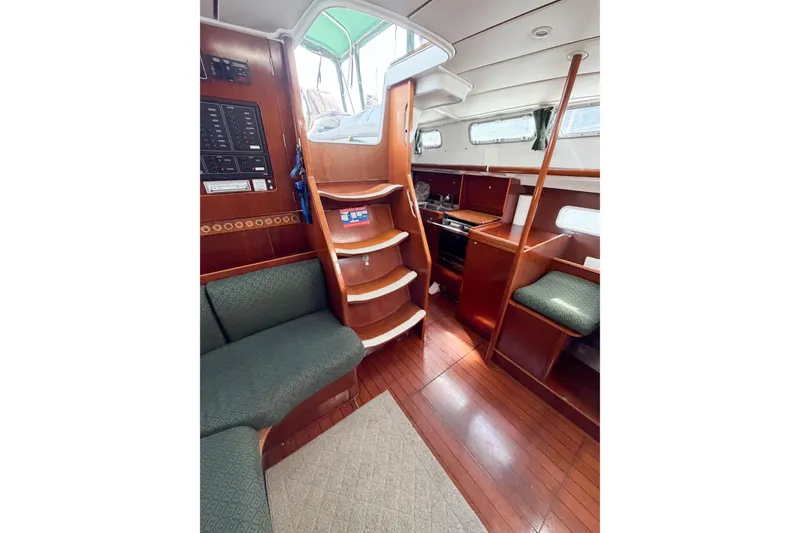 Slide: The Image of Interior of 2002 Beneteau Oceanis 42CC sailboat with wooden finish and seating area. - 40