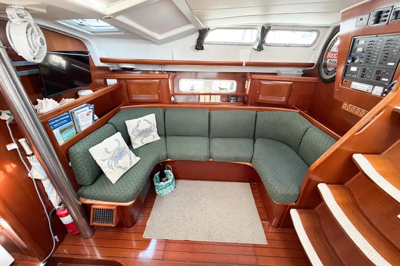 Slide: The Image of Luxurious interior of 2002 Beneteau Oceanis 42CC yacht with elegant wood finish and cozy seating. - 42