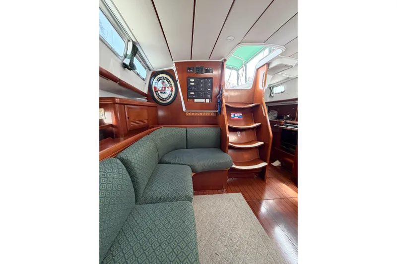 Slide: The Image of Interior of 2002 Beneteau Oceanis 42CC yacht with cozy seating and wooden finishes. - 44