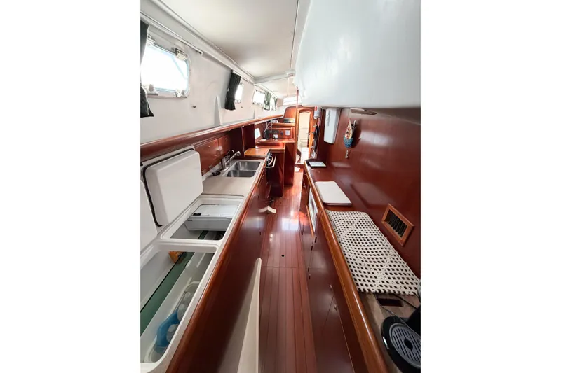 Slide: The Image of Interior of 2002 Beneteau Oceanis 42CC yacht with wooden cabinetry and modern amenities. - 48
