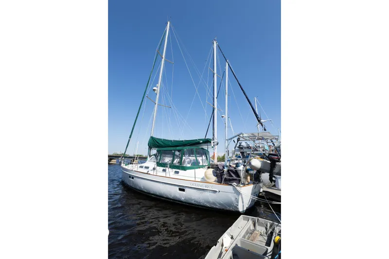 Slide: The Image of 2002 Beneteau Oceanis 42CC sailboat docked under clear blue sky. - 5