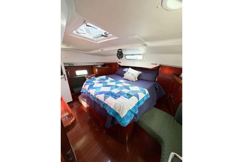 Slide: The Image of Cozy cabin interior of 2002 Beneteau Oceanis 42CC with quilted bedspread. - 50
