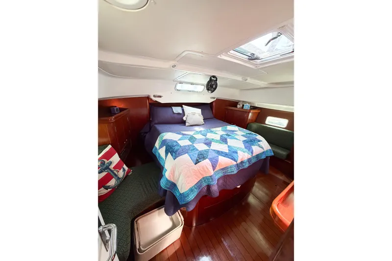 Slide: The Image of Cozy cabin interior of 2002 Beneteau Oceanis 42CC with quilted bedspread. - 51