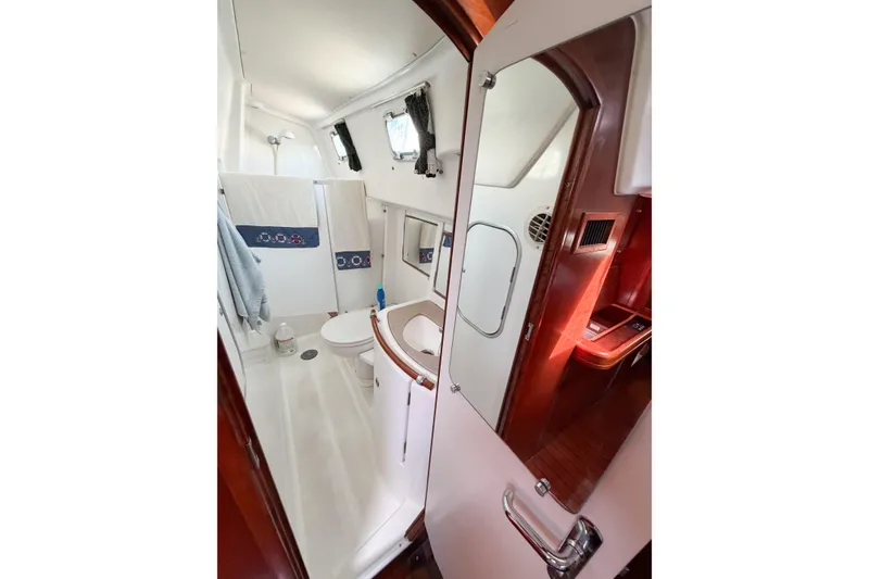 Slide: The Image of Bathroom interior of 2002 Beneteau Oceanis 42CC yacht, featuring modern fixtures and wooden accents. - 53