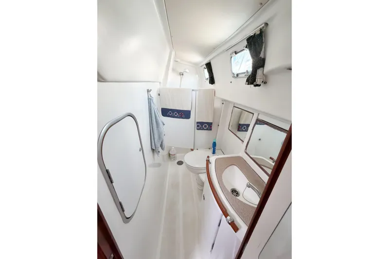 Slide: The Image of Bathroom interior of 2002 Beneteau Oceanis 42CC yacht, featuring sink and toilet. - 54