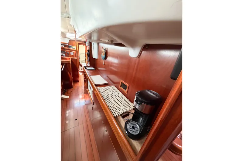 Slide: The Image of Interior of 2002 Beneteau Oceanis 42CC yacht with wooden cabinetry and coffee maker. - 61