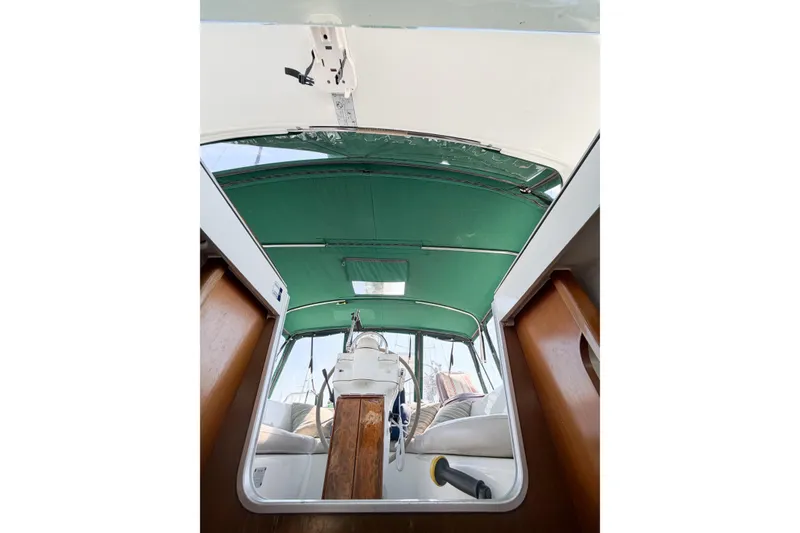 Slide: The Image of Interior view of 2002 Beneteau Oceanis 42CC sailboat with green canopy and steering wheel. - 64