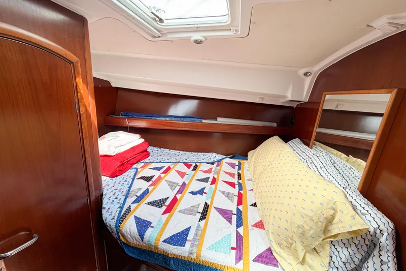 Slide: The Image of Cozy cabin interior of 2002 Beneteau Oceanis 42CC with colorful bedding and wooden accents. - 69