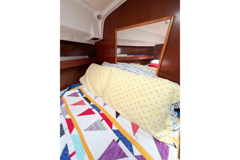 Slide: The Image of Cozy cabin interior of 2002 Beneteau Oceanis 42CC with colorful bedding and wooden accents. - 70