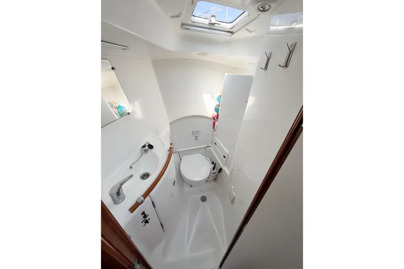 Slide: The Image of Bathroom interior of 2002 Beneteau Oceanis 42CC yacht, featuring compact design and skylight. - 71