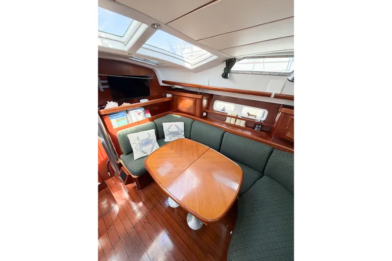 Slide: The Image of Interior of 2002 Beneteau Oceanis 42CC yacht with elegant wood finish and cozy seating. - 78