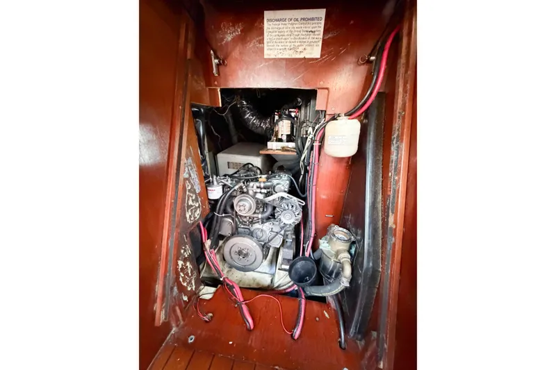 Slide: The Image of Engine compartment of a 2002 Beneteau Oceanis 42CC sailboat, showcasing mechanical components. - 80