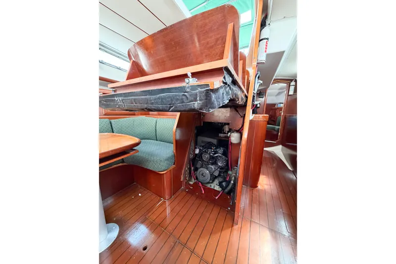 Slide: The Image of Interior view of 2002 Beneteau Oceanis 42CC sailboat, showcasing engine compartment and seating area. - 82
