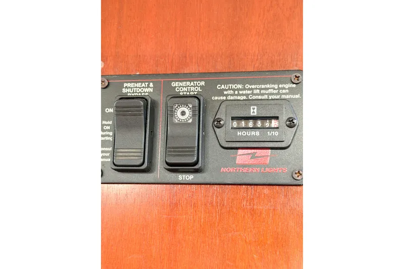 Slide: The Image of Control panel of a 2002 Beneteau Oceanis 42CC sailboat with generator controls. - 90