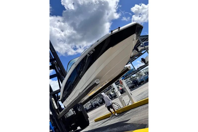 Slide: The Image of 2022 NauticStar 223DC Sport Deck boat displayed on a stand in a marina. - 13