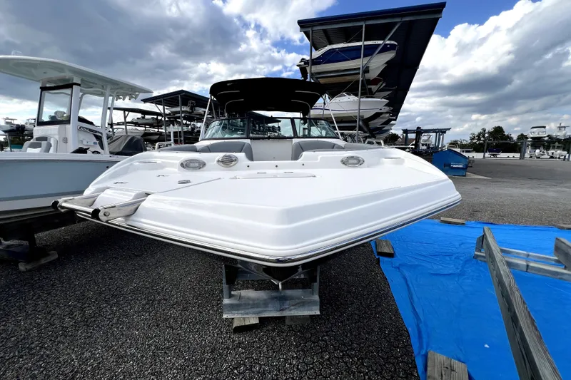 Slide: The Image of 2022 NauticStar 223DC Sport Deck boat on display under cloudy sky. - 15