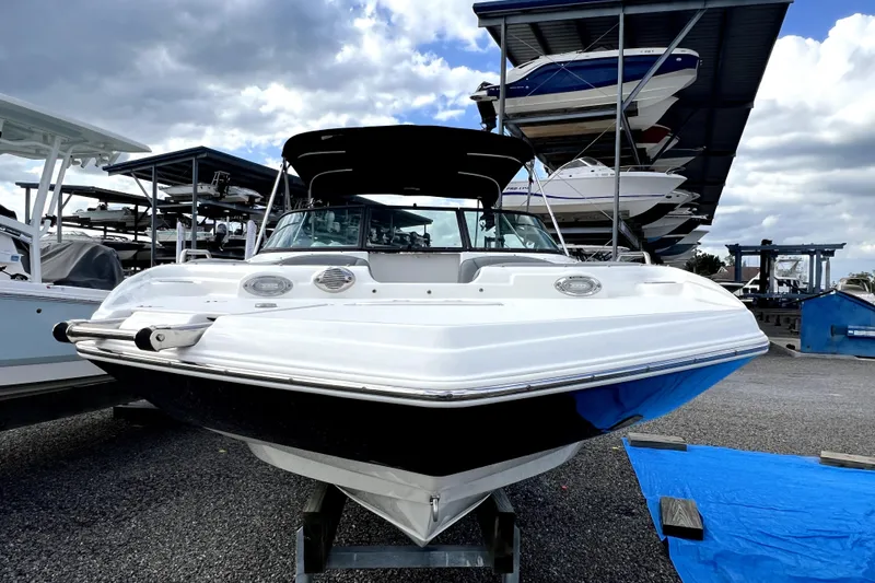 Slide: The Image of 2022 NauticStar 223DC Sport Deck boat in storage, under a cloudy sky. - 16