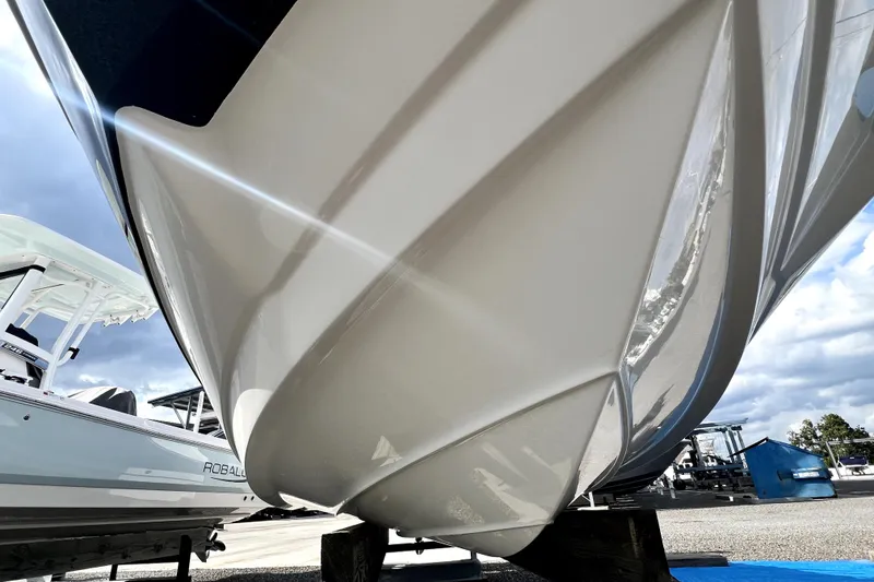 Slide: The Image of 2022 NauticStar 223DC Sport Deck boat hull on display outdoors. - 21