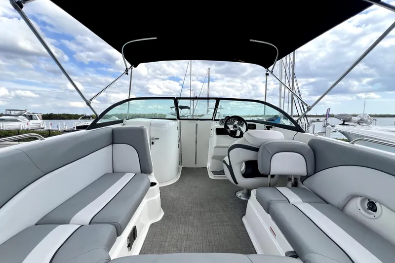 Slide: The Image of 2022 NauticStar 223DC Sport Deck boat interior with gray seating and steering wheel. - 25
