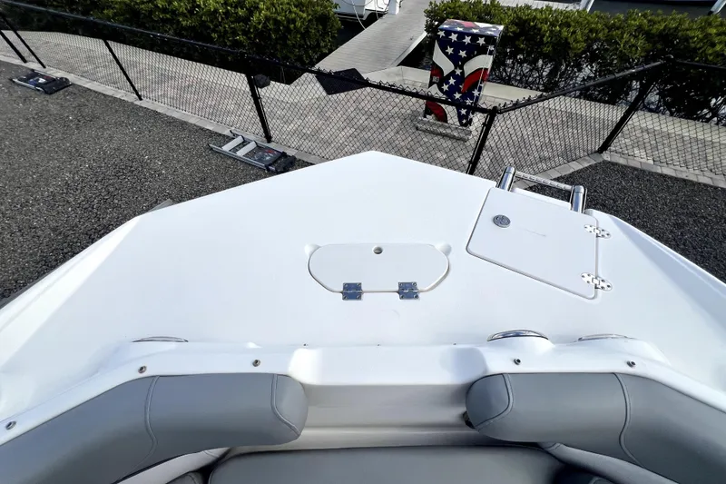 Slide: The Image of 2022 NauticStar 223DC Sport Deck boat bow with seating and storage compartments. - 31