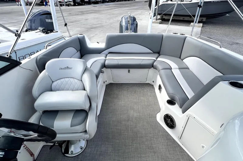 Slide: The Image of 2022 NauticStar 223DC Sport Deck interior with gray seating and modern design. - 40