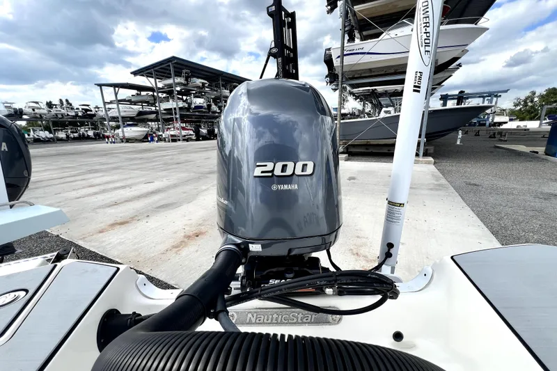 Slide: The Image of 2022 NauticStar 223DC Sport Deck with Yamaha 200 outboard motor at marina. - 44