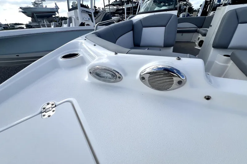 Slide: The Image of 2022 NauticStar 223DC Sport Deck boat interior with seating and speaker detail. - 45