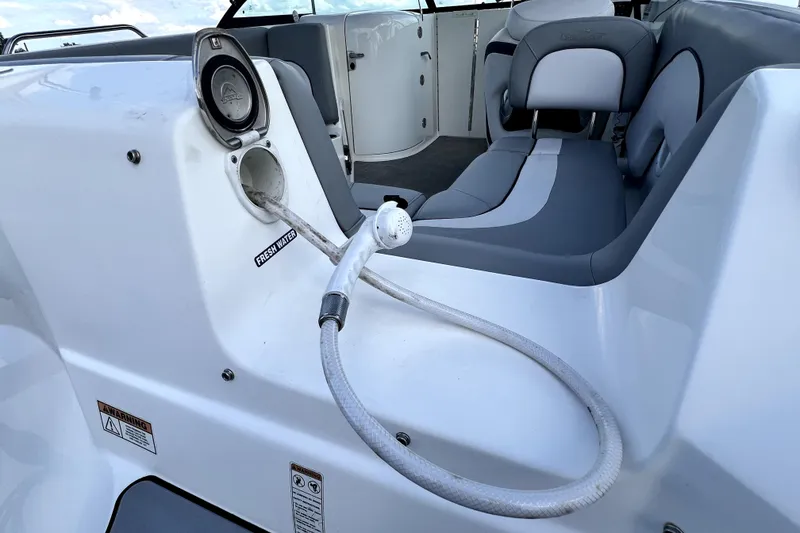 Slide: The Image of 2022 NauticStar 223DC Sport Deck boat interior with fresh water hose and seating. - 47