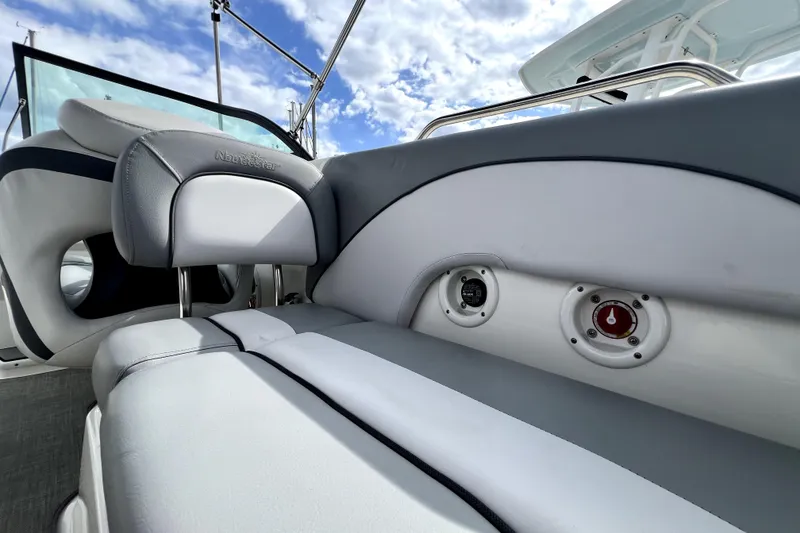Slide: The Image of 2022 NauticStar 223DC Sport Deck boat interior with plush seating and control panels. - 48