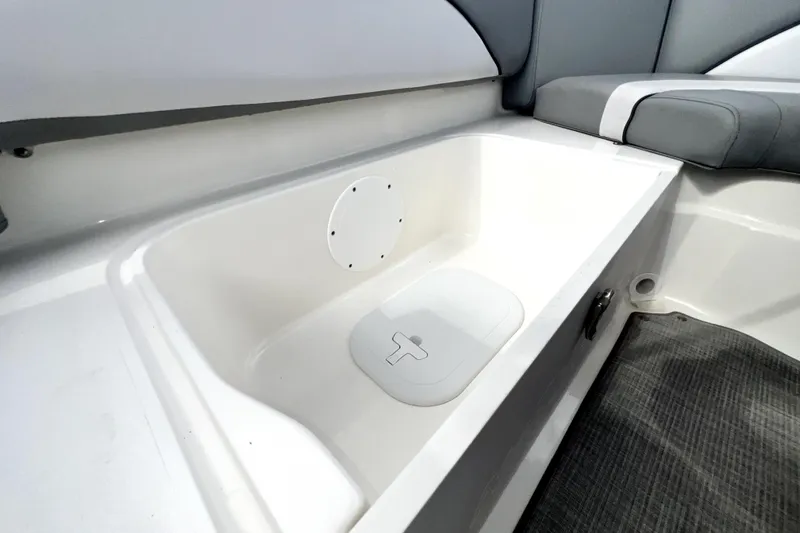 Slide: The Image of 2022 NauticStar 223DC Sport Deck interior storage compartment with cushioned seating. - 53
