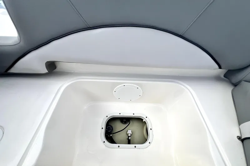 Slide: The Image of 2022 NauticStar 223DC Sport Deck interior storage compartment detail. - 55