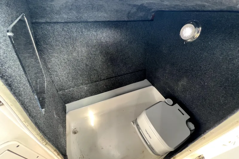 Slide: The Image of Interior of 2022 NauticStar 223DC Sport Deck boat with portable toilet. - 67