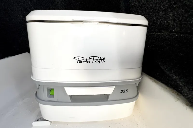 Slide: The Image of Portable toilet on 2022 NauticStar 223DC Sport Deck boat interior. - 69