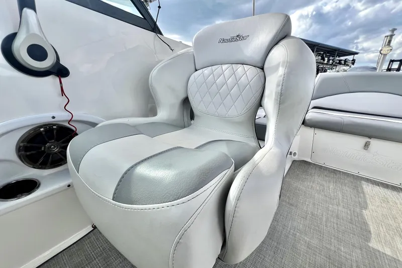 Slide: The Image of 2022 NauticStar 223DC Sport Deck boat seat with quilted design and speaker. - 71