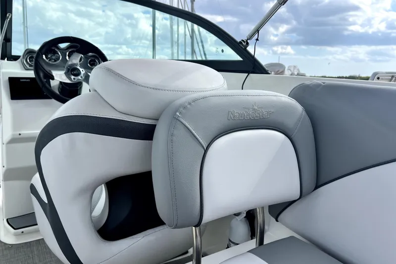 Slide: The Image of 2022 NauticStar 223DC Sport Deck boat interior with plush seating and steering wheel. - 73