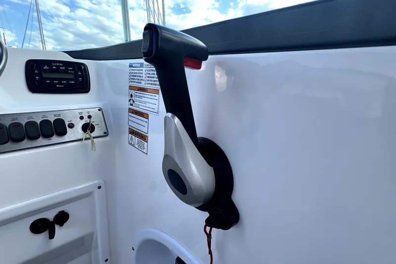 Slide: The Image of Throttle control and dashboard of 2022 NauticStar 223DC Sport Deck boat. - 79