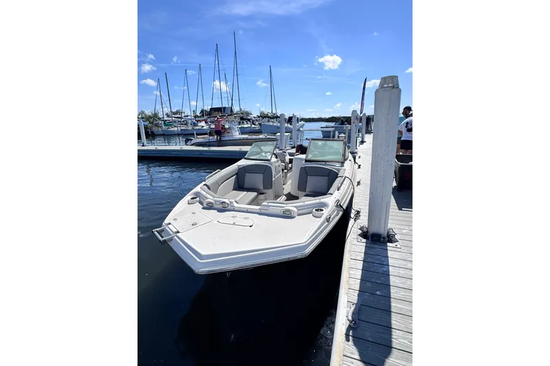 Slide: The Image of Close-up of a 2022 NauticStar 223DC Sport Deck boat propeller on gravel. - 8
