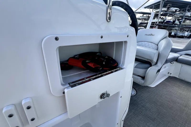 Slide: The Image of 2022 NauticStar 223DC Sport Deck boat interior with storage compartment and seating. - 81