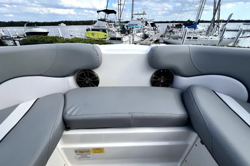Slide: The Image of Interior view of a 2022 NauticStar 223DC Sport Deck boat with gray seating. - 85