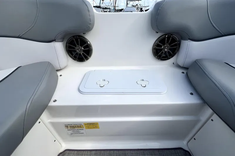 Slide: The Image of 2022 NauticStar 223DC Sport Deck interior with gray seating and built-in speakers. - 86