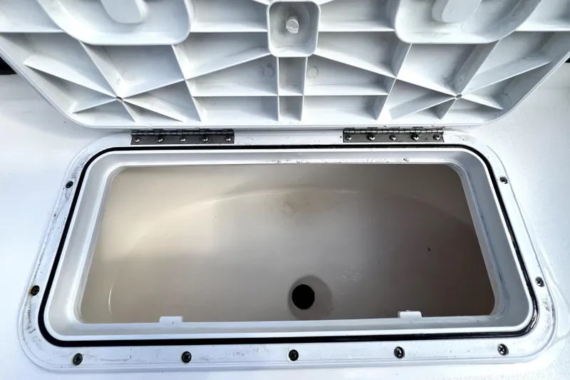 Slide: The Image of Open storage compartment on 2022 NauticStar 223DC Sport Deck boat. - 88